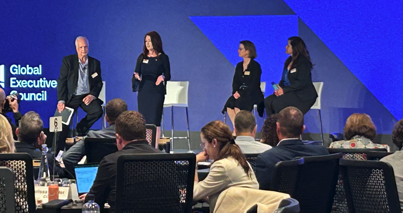 April Romero speaking on a panel at PMI Global Executive Council in 2025 April Romero speaking on a panel at PMI Global Executive Council in 2025